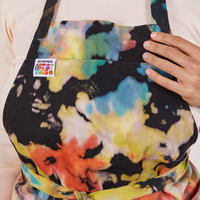 Front close up of Artist Togs Full Apron in Rainbow Magic Waters on Tiara. Waist straps are tied in a front bow.