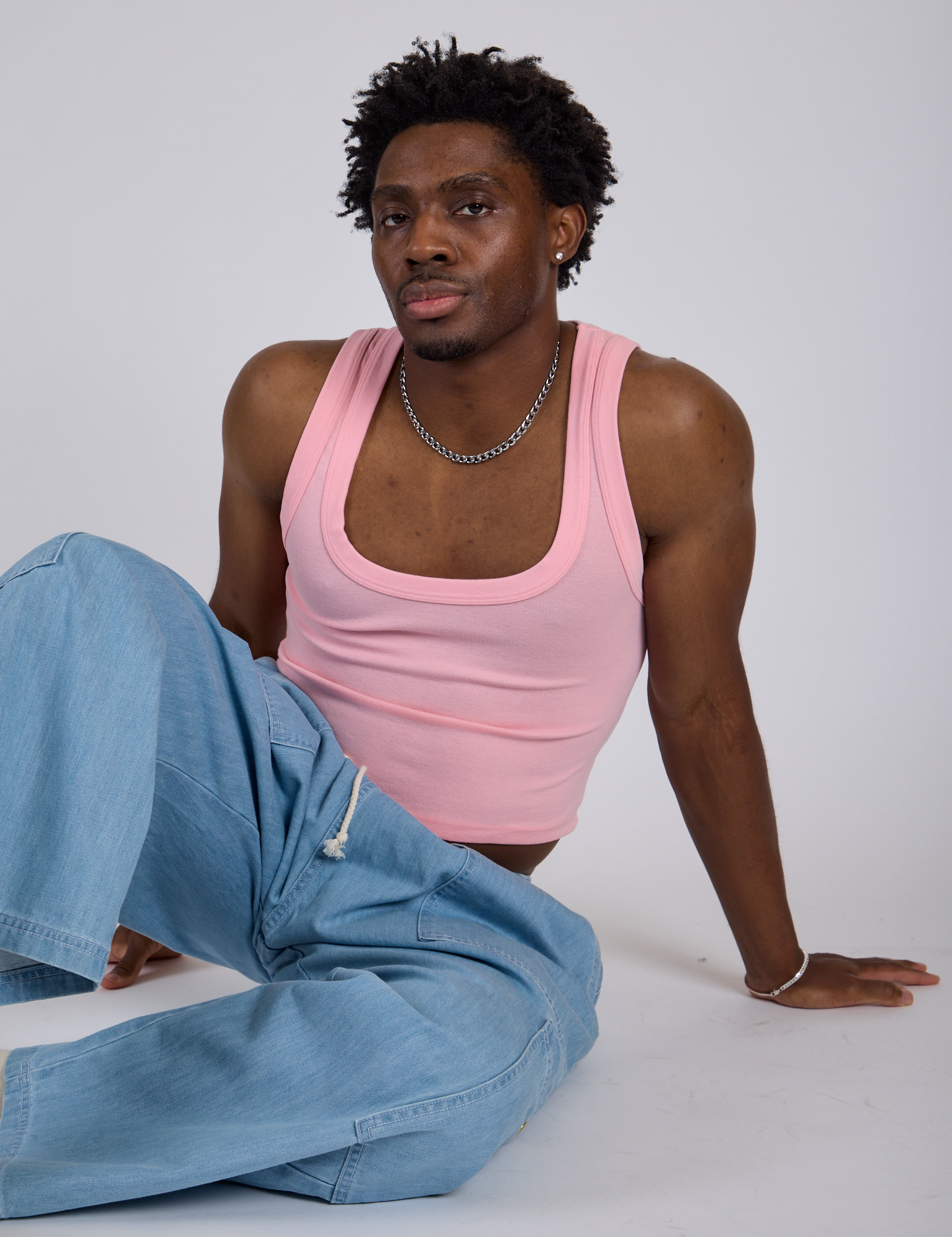 Isaac is wearing Cropped Tank Top in Baby Pink