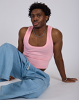 Isaac is wearing Cropped Tank Top in Baby Pink