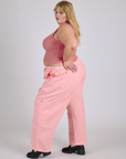 Side view of Drop Pocket Cargo Pants in Baby Pink and muscle tee on Juliet