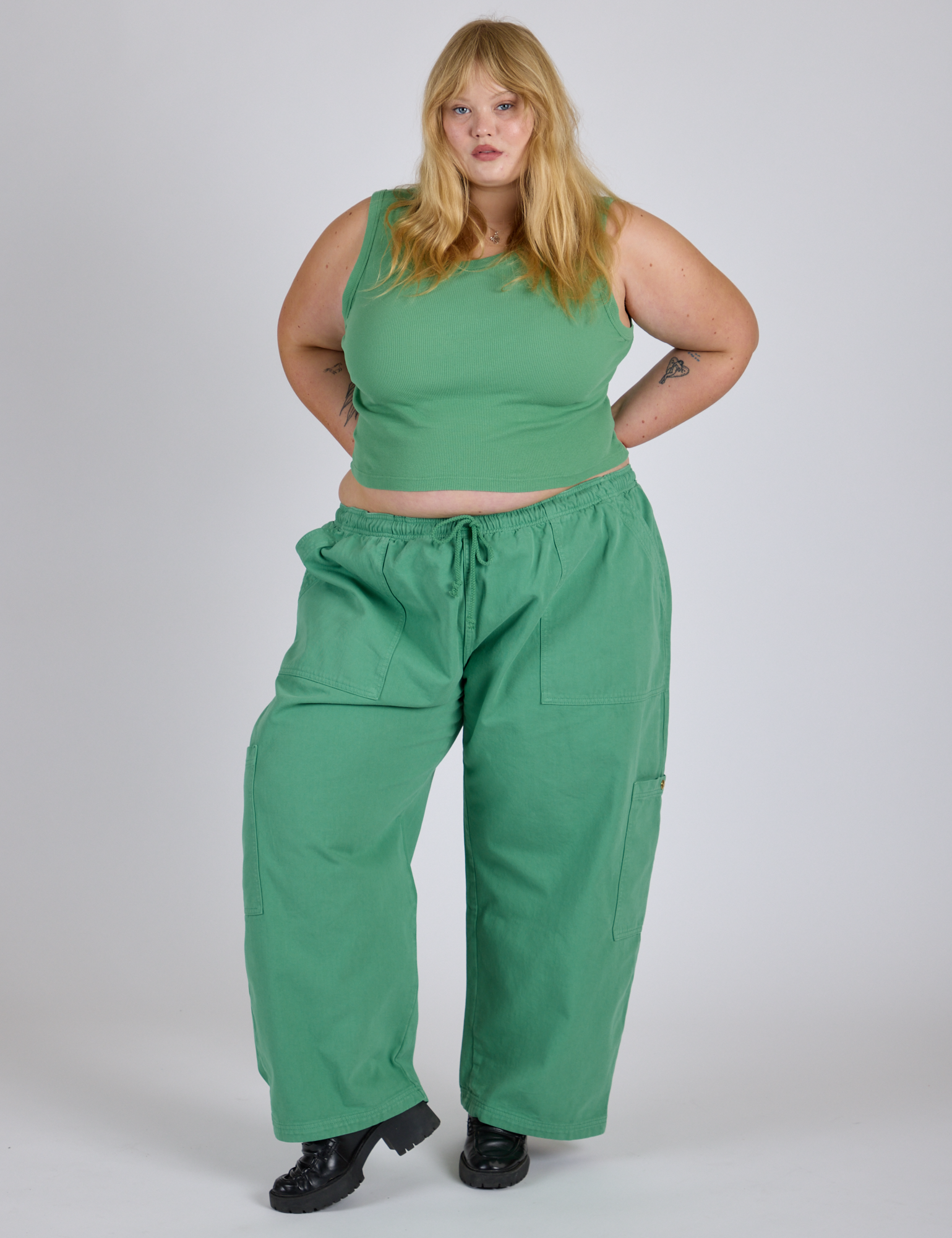 Juliet is 5’7” and wearing 2XL Drop Pocket Cargo Pants in Seafoam Green paired with matching Muscle Tee
