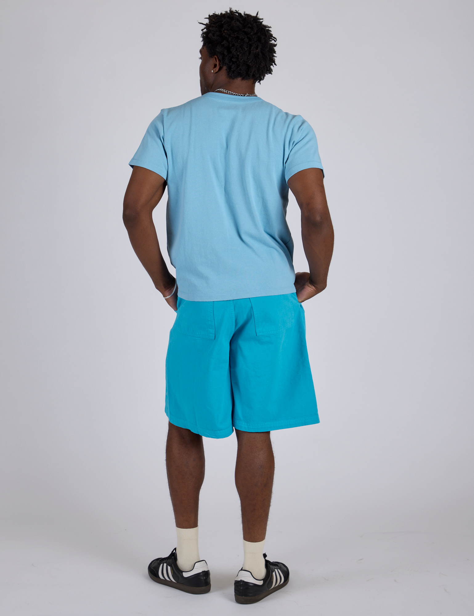 Back view of Longline Work Shorts in Hawaiian Blue and baby blue Organic Vintage Tee on Isaac