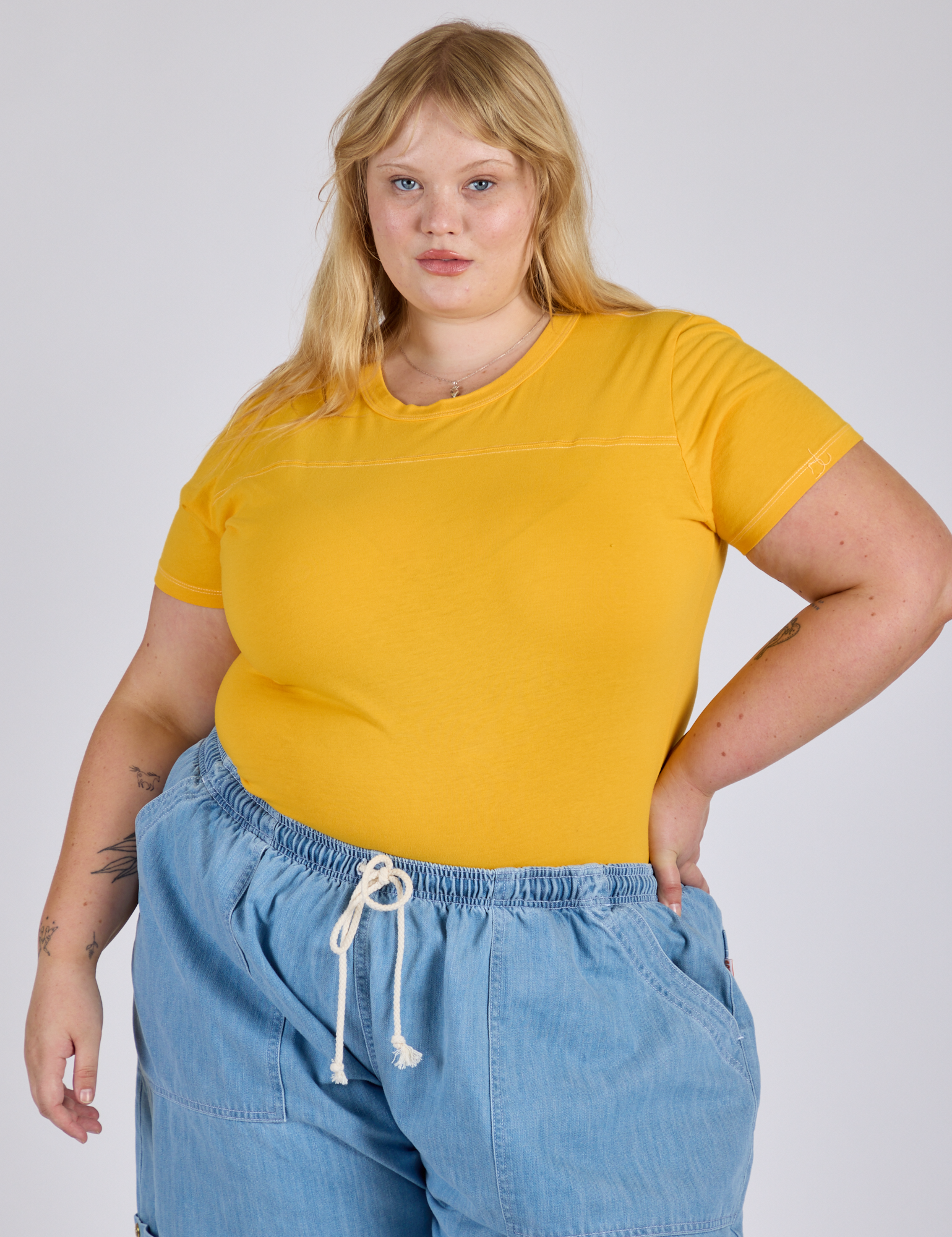 Juliet is wearing Jr. Varsity Tee in Sunshine Yellow