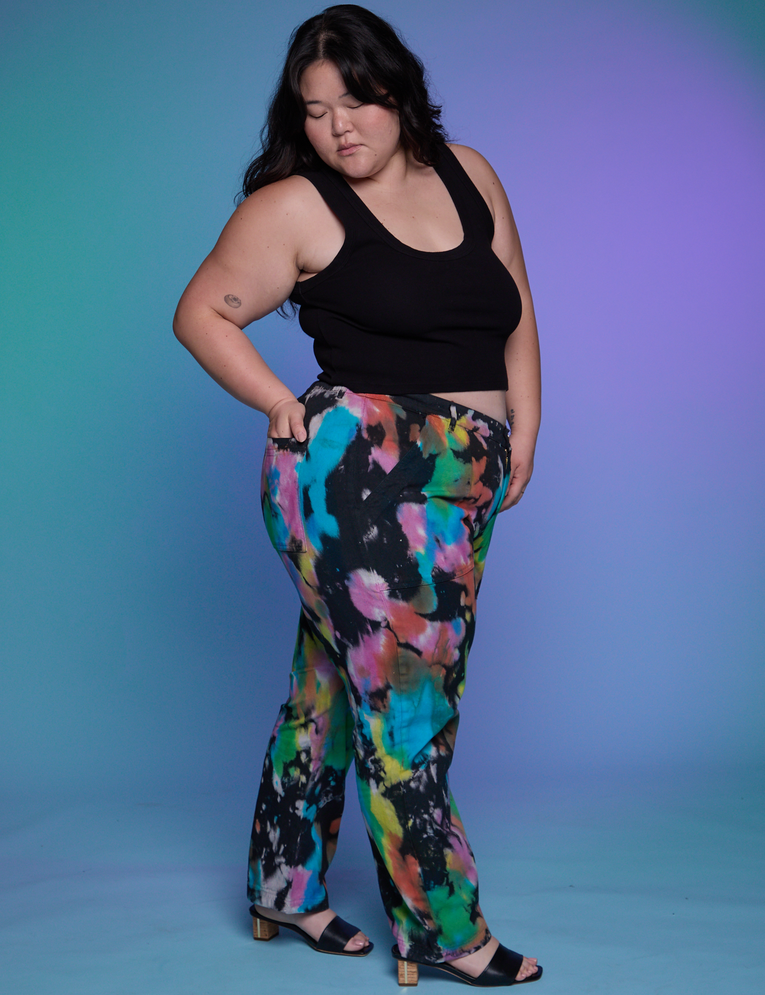 Side view of Work Pants in Rainbow Magic Waters and black Cropped Tank on Ashley
