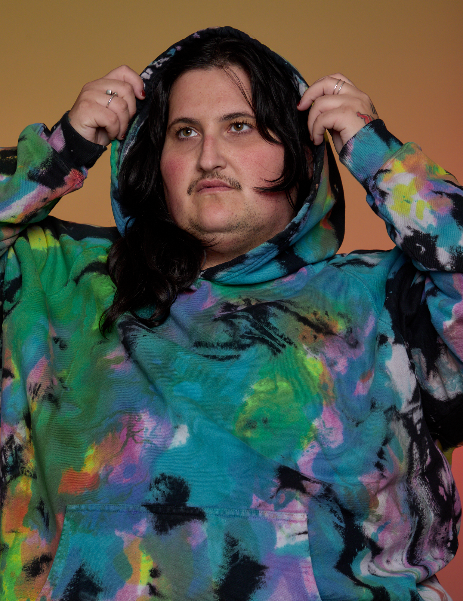 Oversized Hoodie in Rainbow Magic Waters front close up on Sam with hood on