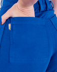 Bell Bottoms in Royal Blue back pocket close up with Alex's hand in the pocket