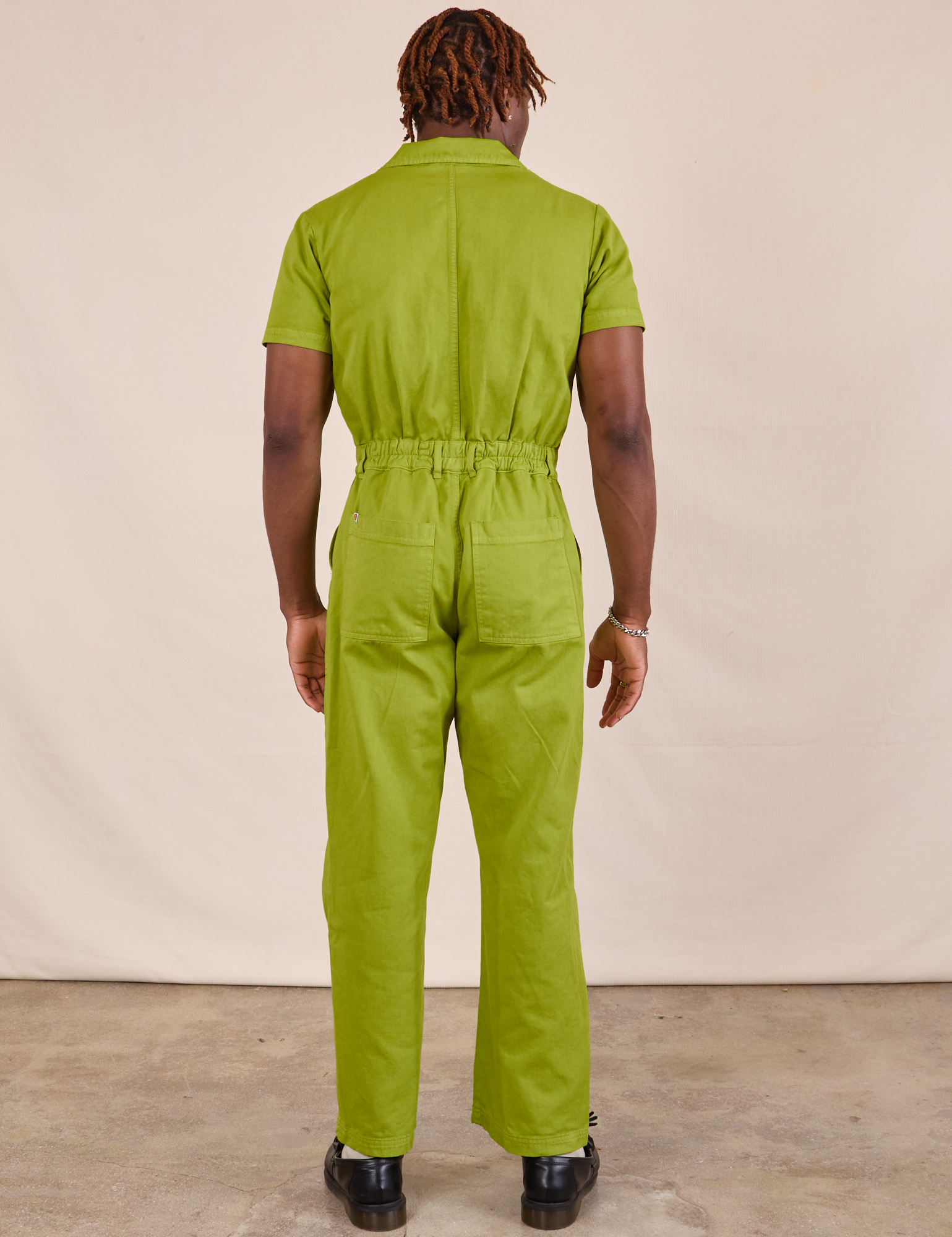 Short Sleeve Jumpsuit in Gross Green back view on Issac