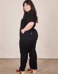 Angled back view of Short Sleeve Jumpsuit in Basic Black worn by Ashley