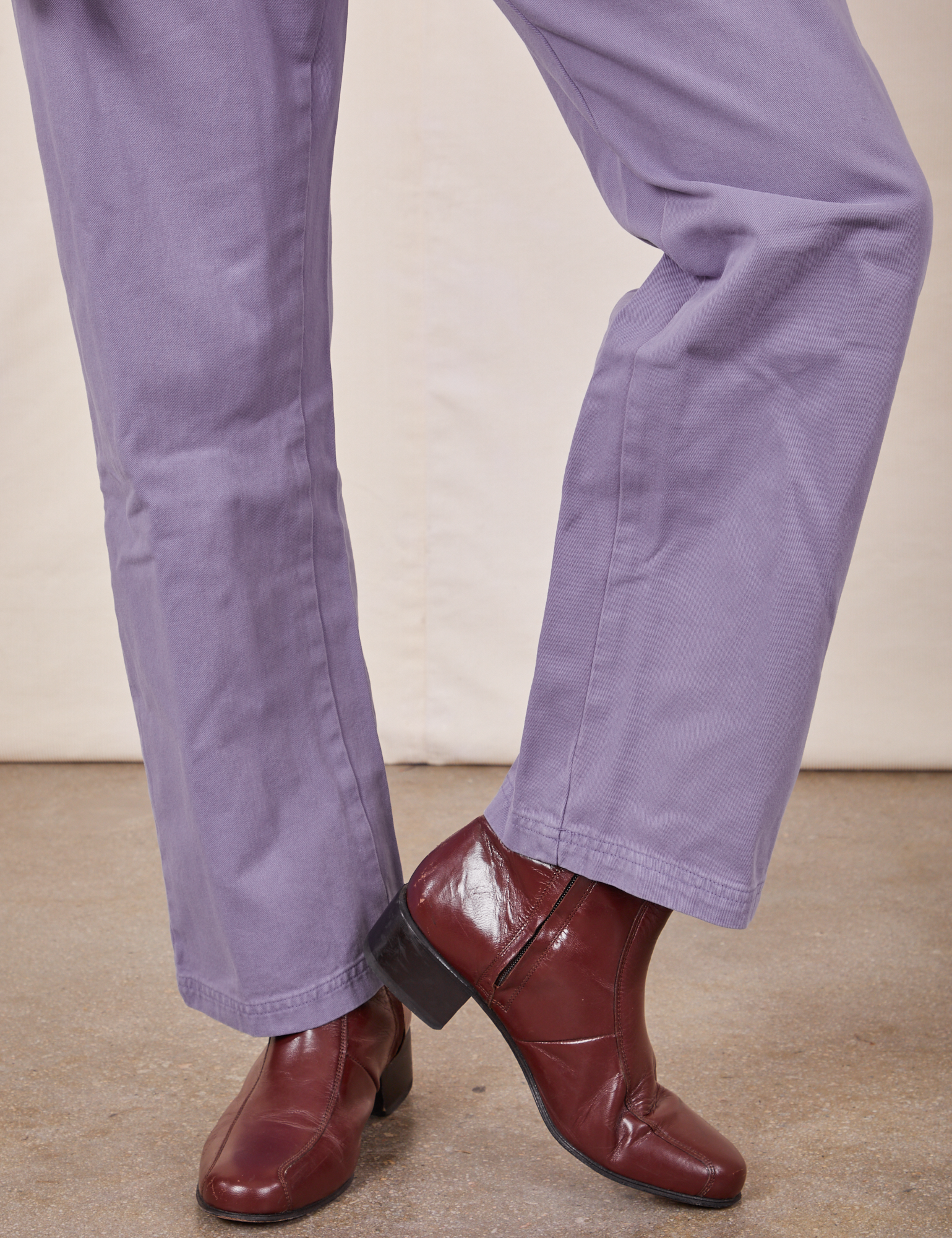 Pant leg close up of Short Sleeve Jumpsuit in Faded Grape worn by Jesse