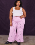 Morgan is 5'5" and wearing 1XL Star Bell Bottoms in Lilac Purple paired with a Cropped Tank in vintage tee off-white