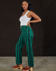Side view of Black Stripe Work Pants in Hunter and vintage off-white Cropped Tank Top on Kandia