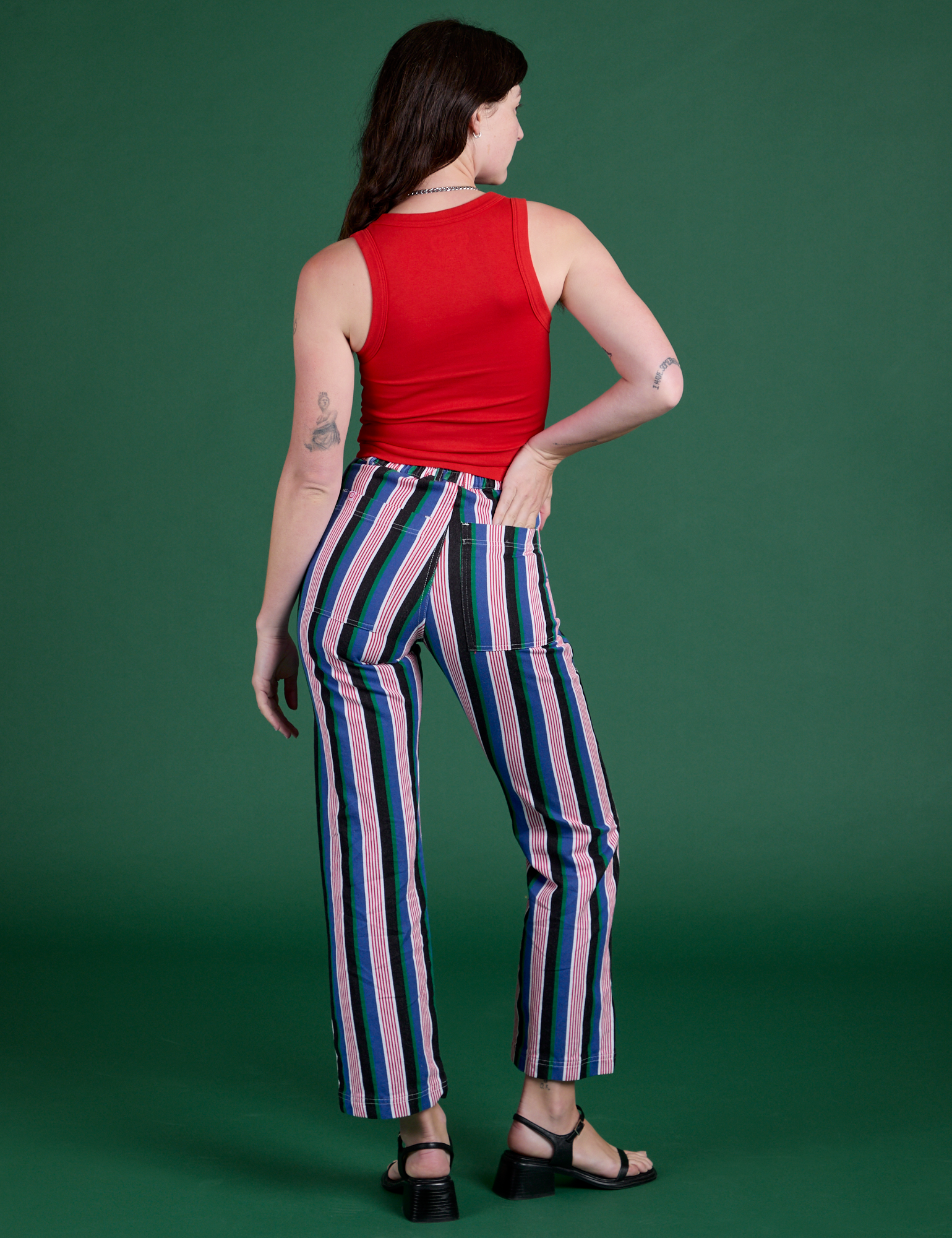 Back view of Work Pants in Pacific Stripe and mustang red Tank Top on Alex