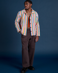 Isaac is wearing  Stripe Work Jacket in Rainbow Stripe paired with espresso Work Pants 