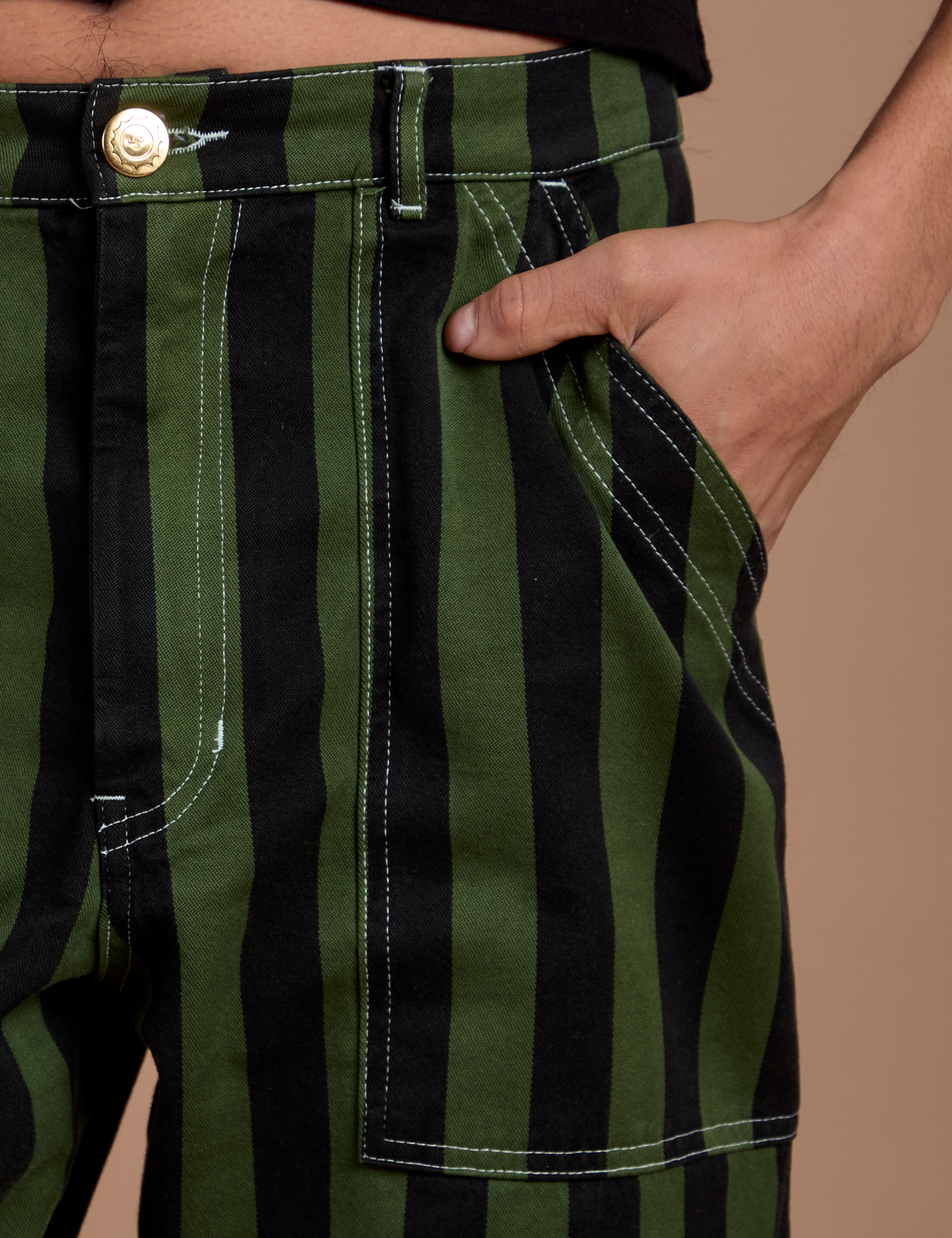 Close up of Anthony's hand in the front pocket of Black Stripe Work Pants in Evergreen
