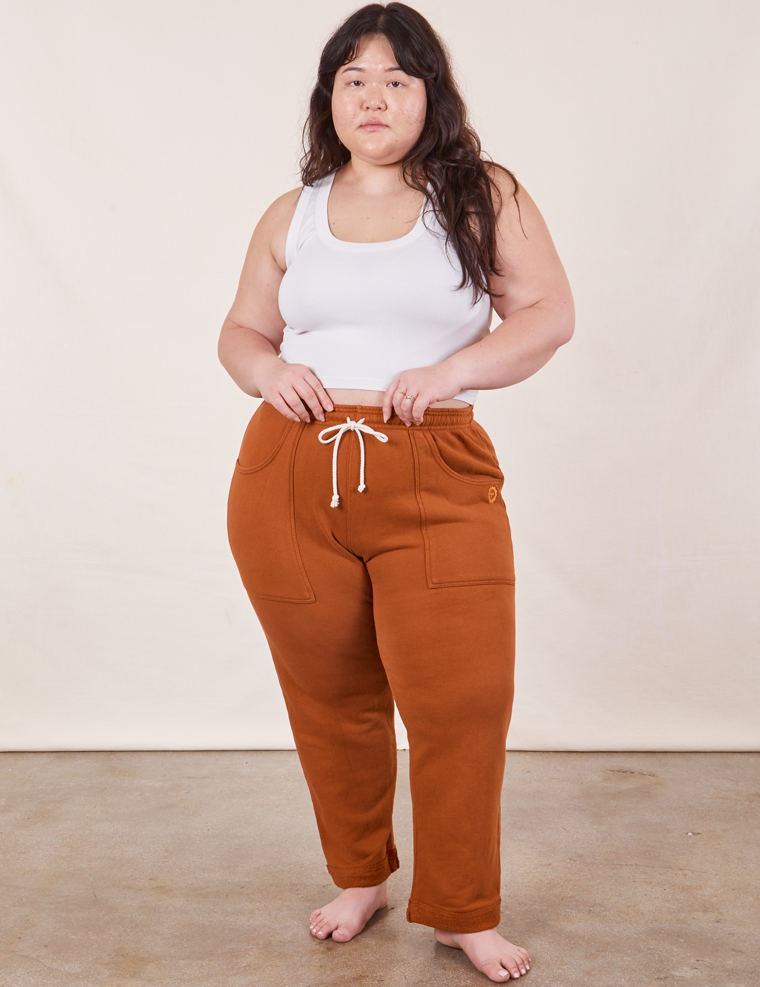 Ashley is 5&#39;7&quot; and wearing XL Cropped Rolled Cuff Sweatpants in Burnt Terracotta paired with vintage off-white Cropped Tank Top