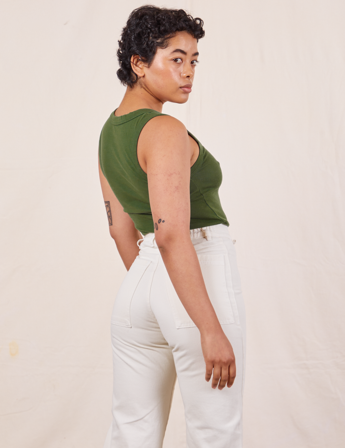 Tank Top in Dark Emerald Green back view on Mika wearing vintage off-white Western Pants