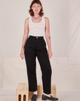 Alex is 5'8" and wearing XXS Denim Trouser Jeans in Black paired with a vintage off-white Tank Top
