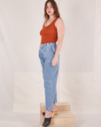 Angled view of Denim Trouser Jeans in Light Wash and burnt orange Tank Top worn by Allison