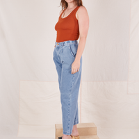 Angled view of Denim Trouser Jeans in Light Wash and burnt orange Tank Top worn by Allison