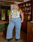 Juliet is wearing Short Sleeve Raglan Tee in Garlic tucked into light wash Indigo Wide Leg Trousers