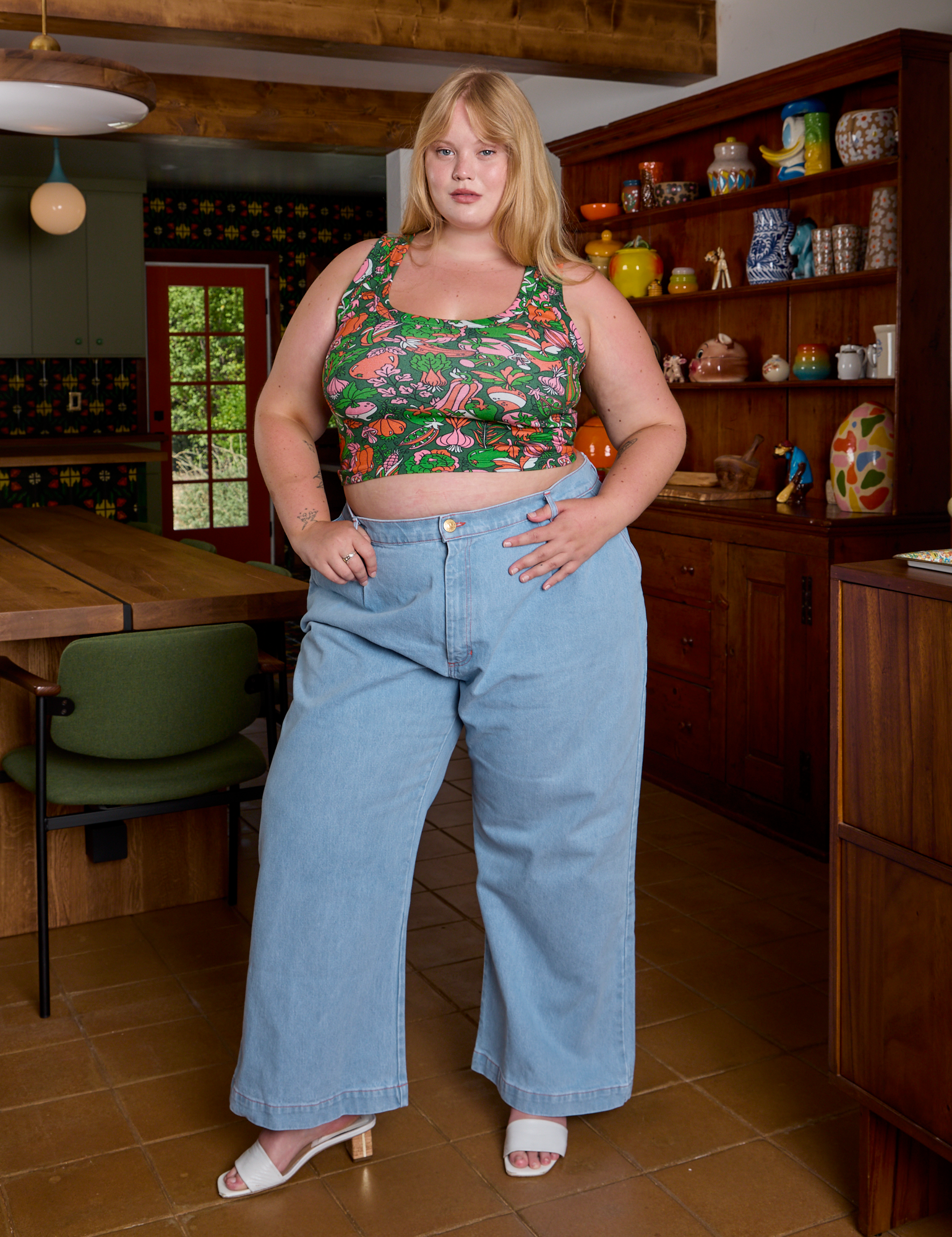 Juliet is wearing Cropped Tank Top in Kitchen Collection and light wash Indigo Wide Leg Trousers