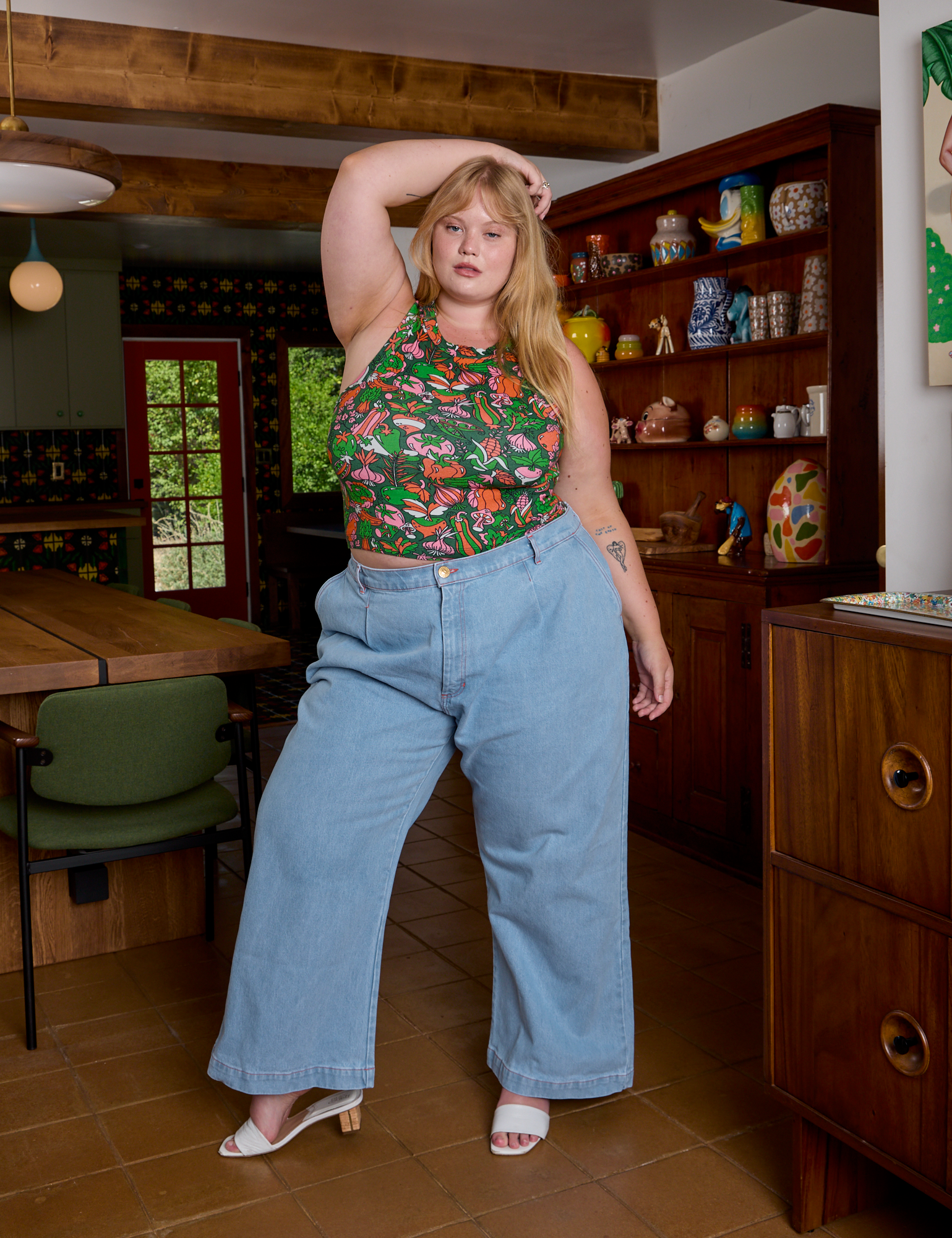 Juliet is wearing Kitchen Collection Racerback Tank and light wash Indigo Wide Leg Trousers