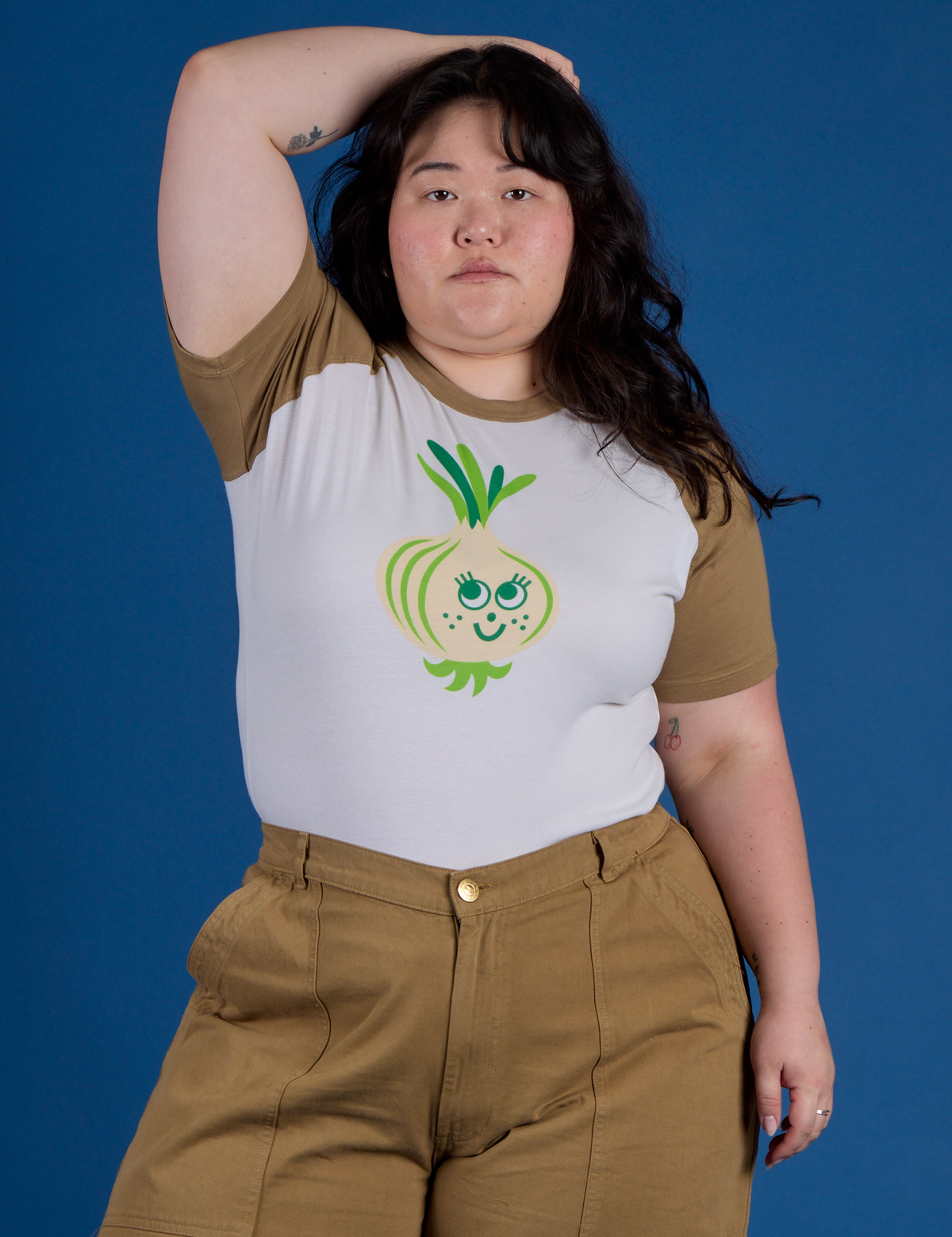 Ashley is wearing Produce Raglan Tee in Onion