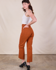 Angled back view of Western Pants in Burnt Terracotta on Alex