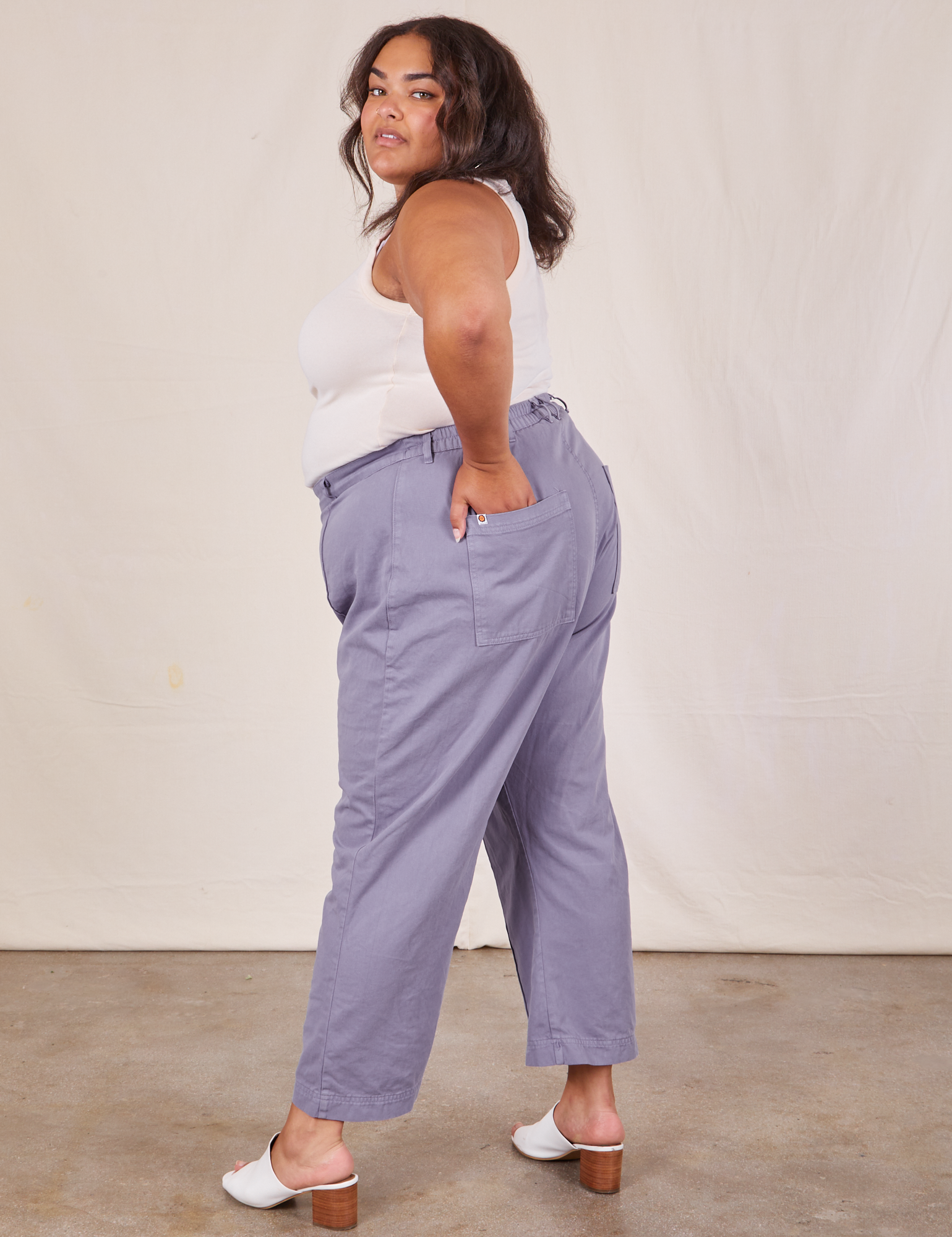 Side view of Western Pants in Faded Grape worn by Alicia. She has her hand in one of the pockets.