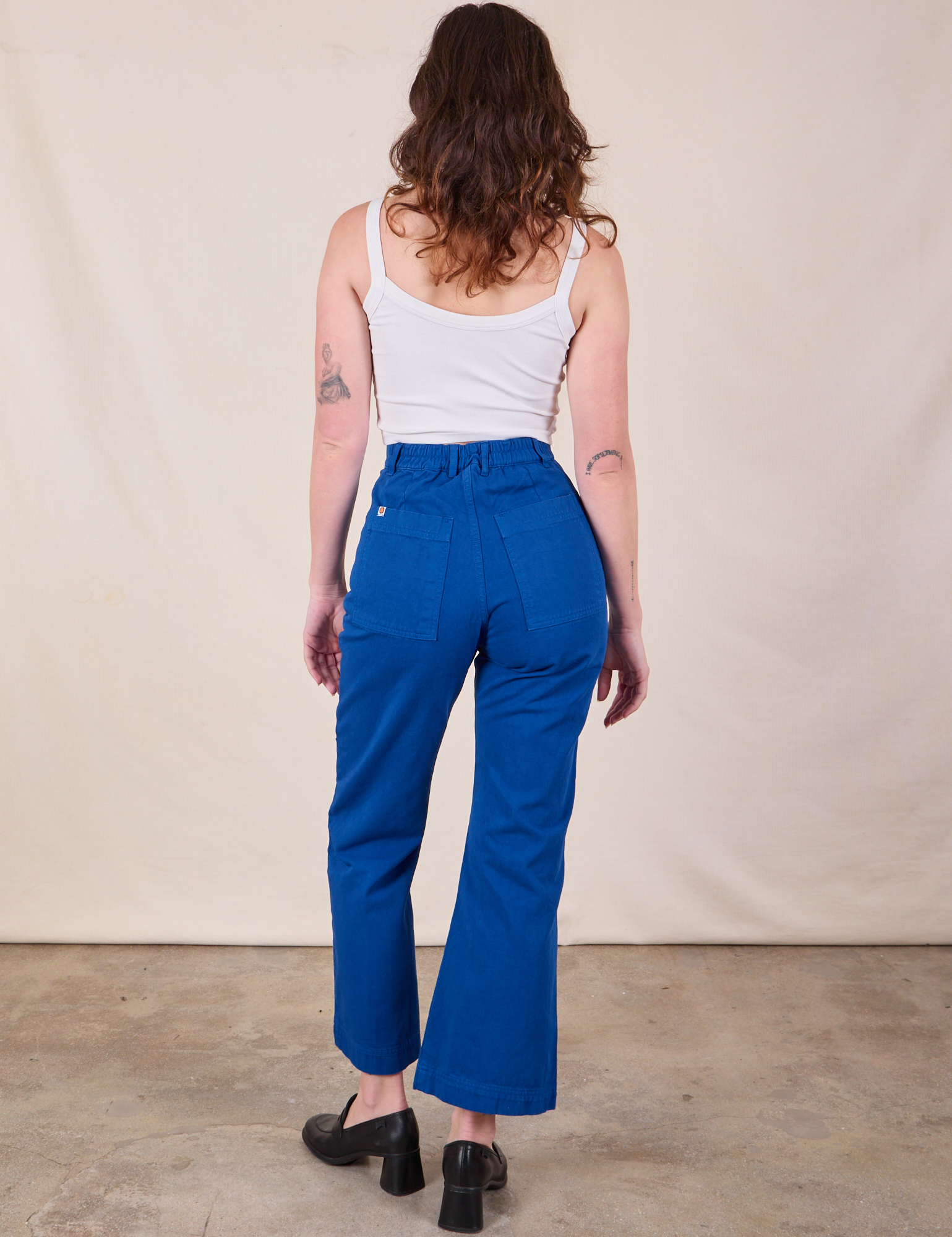 Back view of Western Pants in Royal Blue and Cropped Cami in Vintage Tee Off-White on Alex