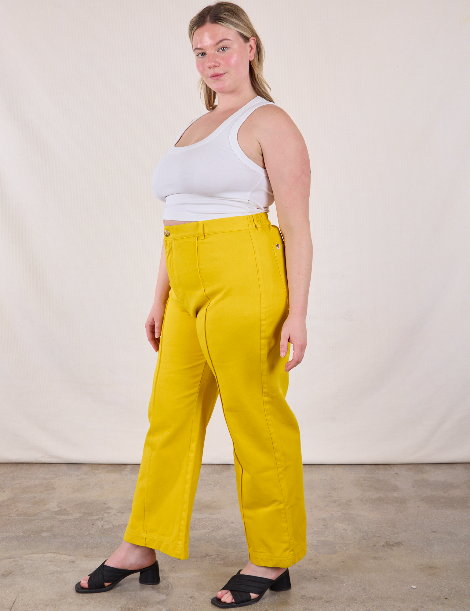 Side view of Western Pants in Golden Yellow and Cropped Tank in Vintage Tee Off-White on Lish