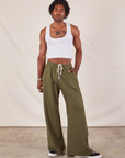 Jerrod is 6'3" and wearing S Wide Leg Sweat Pants in Surplus Green paired with Cropped Tank in vintage tee off-white