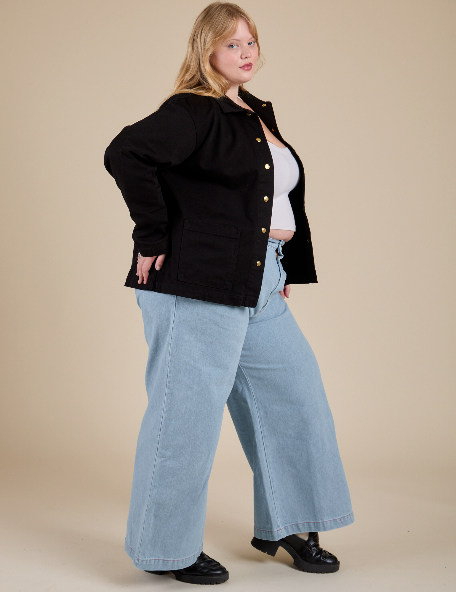 Side view of Work Jacket in Basic Black and light wash Indigo Wide Leg Trousers on Juliet
