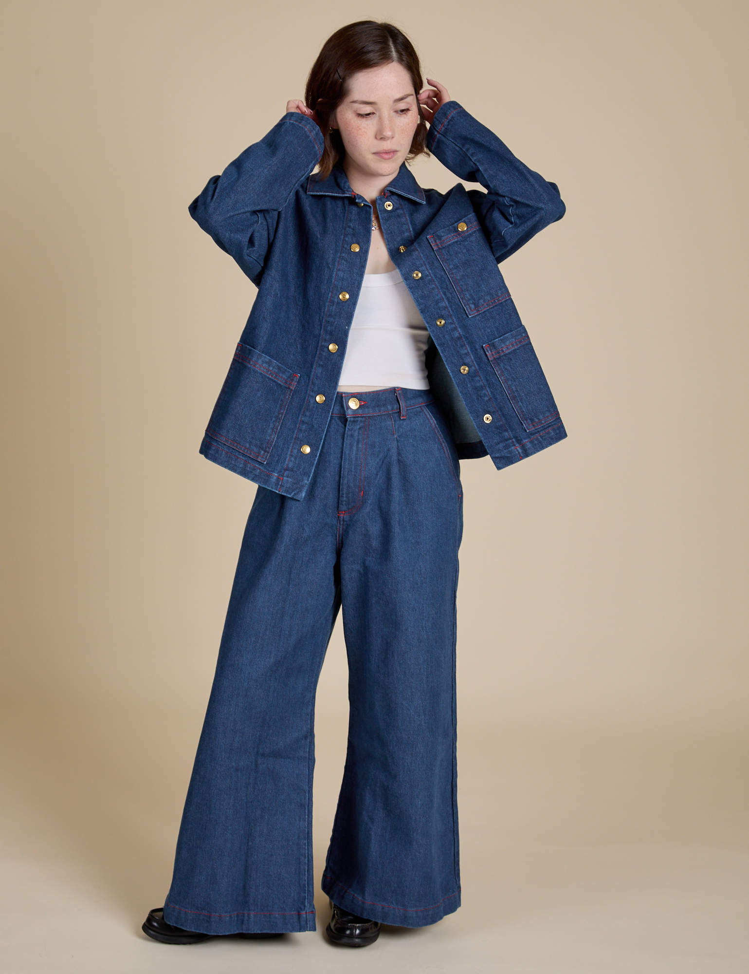 Hana is wearing Indigo Denim Work Jacket in Dark Wash and dark wash Indigo Wide Leg Trousers
