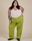 Sam is wearing Work Pants in Gross Green and Cropped Tank in Vintage Tee White