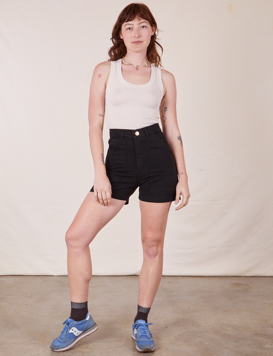 Alex is 5'8" and wearing size XS Classic Work Shorts in Basic Black paired with vintage off-white Tank Top