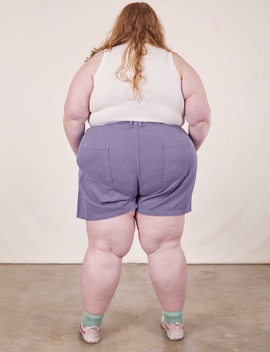 Back view of Classic Work Shorts in Faded Grape and vintage off-white Tank Top worn by Catie