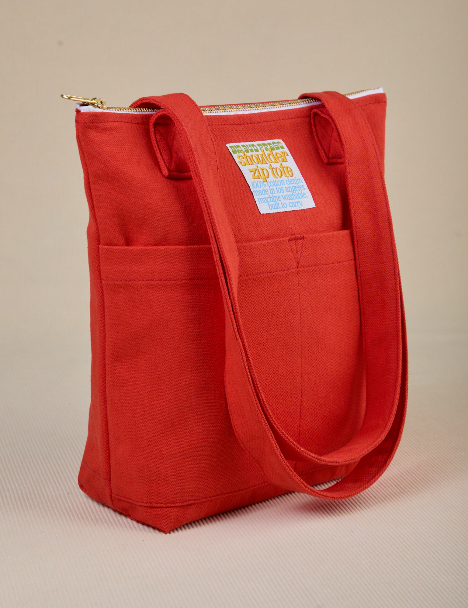 Angled view of Over-Shoulder Zip Mini Tote in Mustang Red
