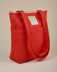 Angled view of Over-Shoulder Zip Mini Tote in Mustang Red