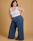 Angled front view of Heritage Wide Leg Trousers in French Blue and vintage tee white Cropped Tank on Ashley