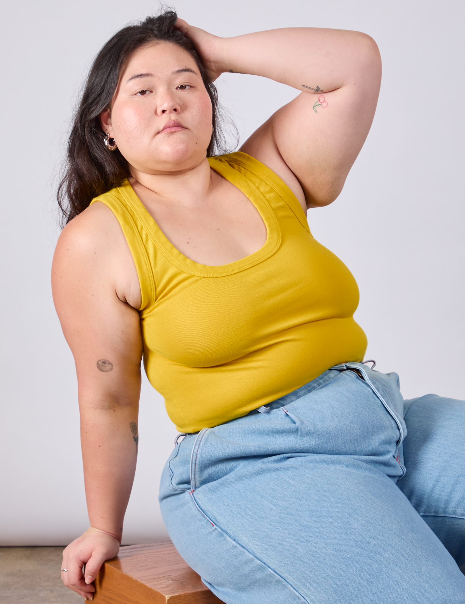 Ashley is wearing Cropped Tank Top in Golden Yellow