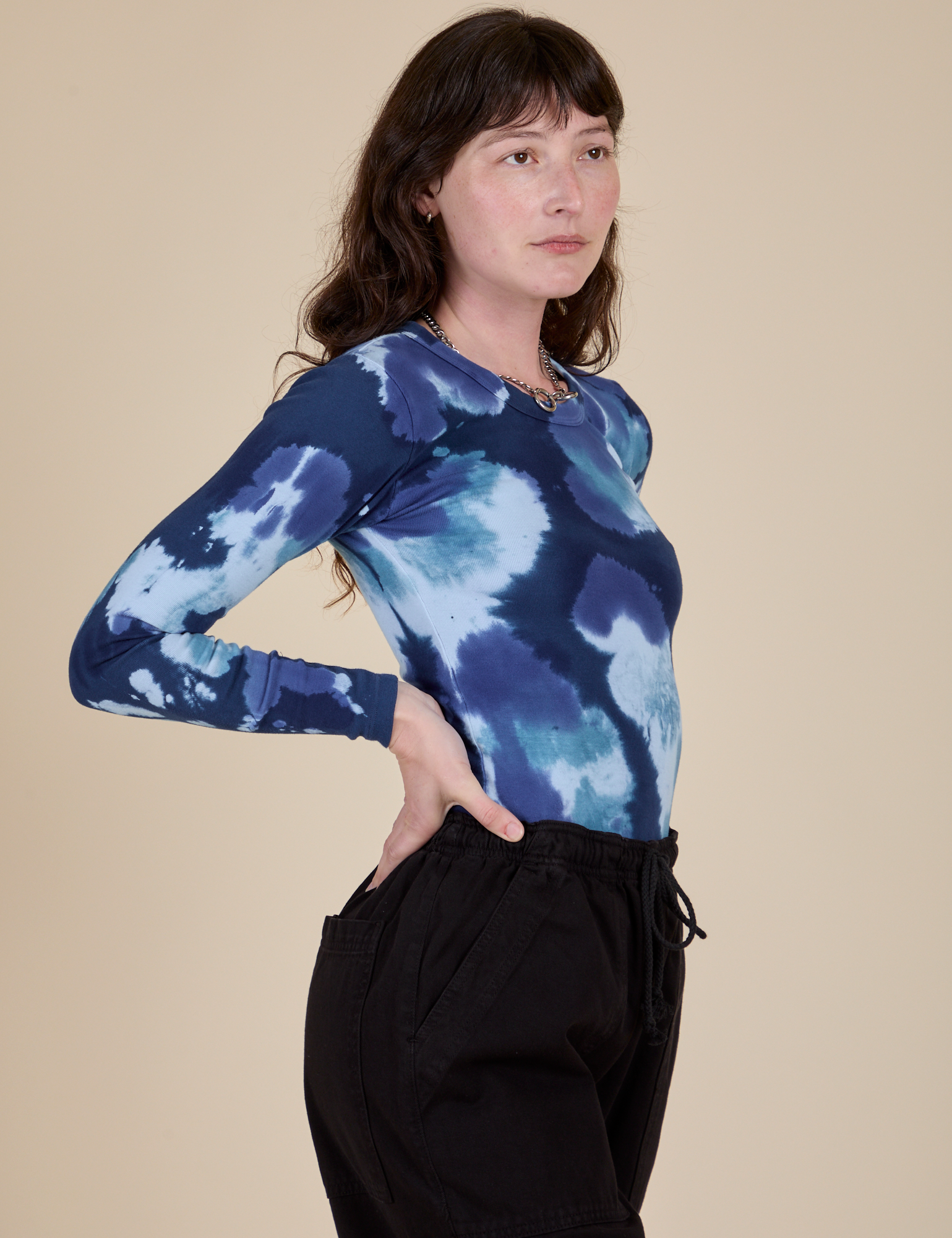 Long Sleeve Baby Tee in Blue Magic Waters side view on Alex