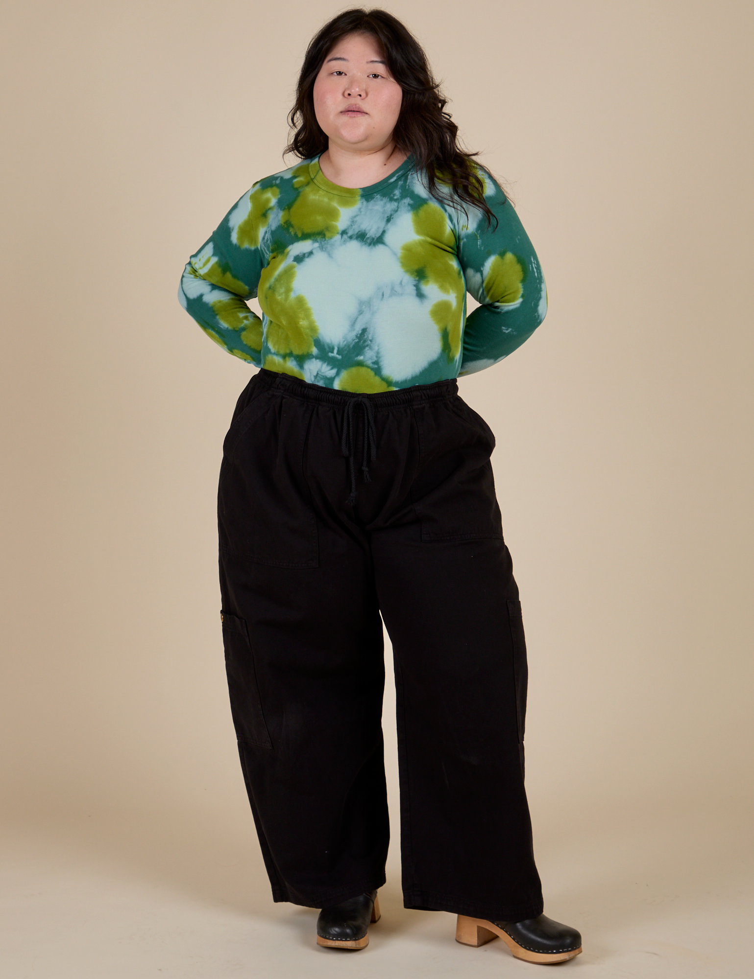 Long Sleeve Baby Tee in Green Magic Waters tucked into black Drop Pocket Cargo Pants