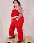 Side view of Mid-Rise Work Pants in Mustang Red and matching Cropped Cami on Sam