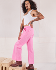 Side view of Action Pants in Bubblegum Pink and Cropped Tank in vintage tee off-white worn by Jesse