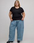 Juliet is wearing Baby Tee in Basic Black and light wash denim drop pocket pants