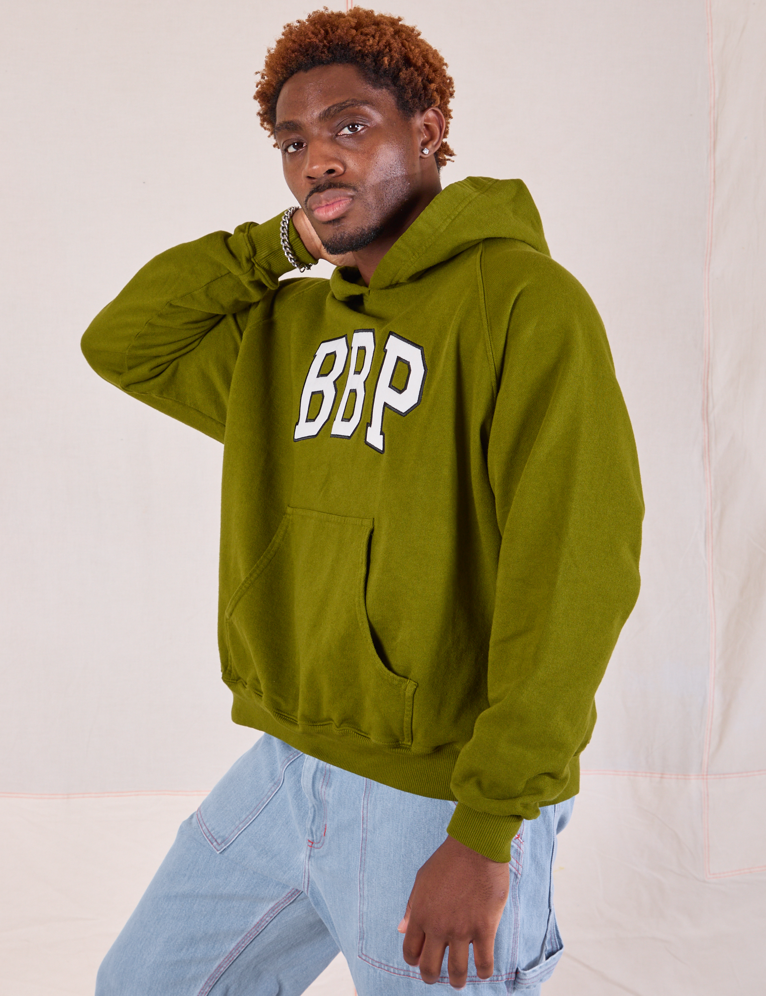 Collegiate Hoodie in Summer Olive angled front view on Issac