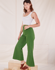 Side view of Bell Bottoms in Lawn Green and vintage off-white Cropped Tank Top