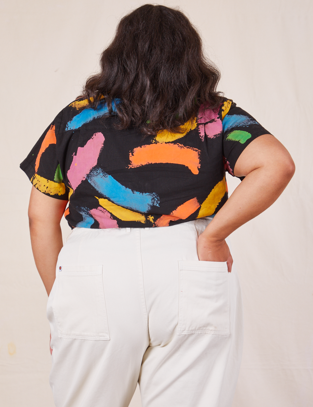 Back view of Pantry Button Up in Paint Stroke tucked into vintage off-white Western Pants. Alicia has her left hand tucked into the back pant pocket.