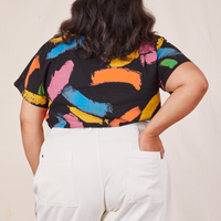 Back view of Pantry Button Up in Paint Stroke tucked into vintage off-white Western Pants. Alicia has her left hand tucked into the back pant pocket.